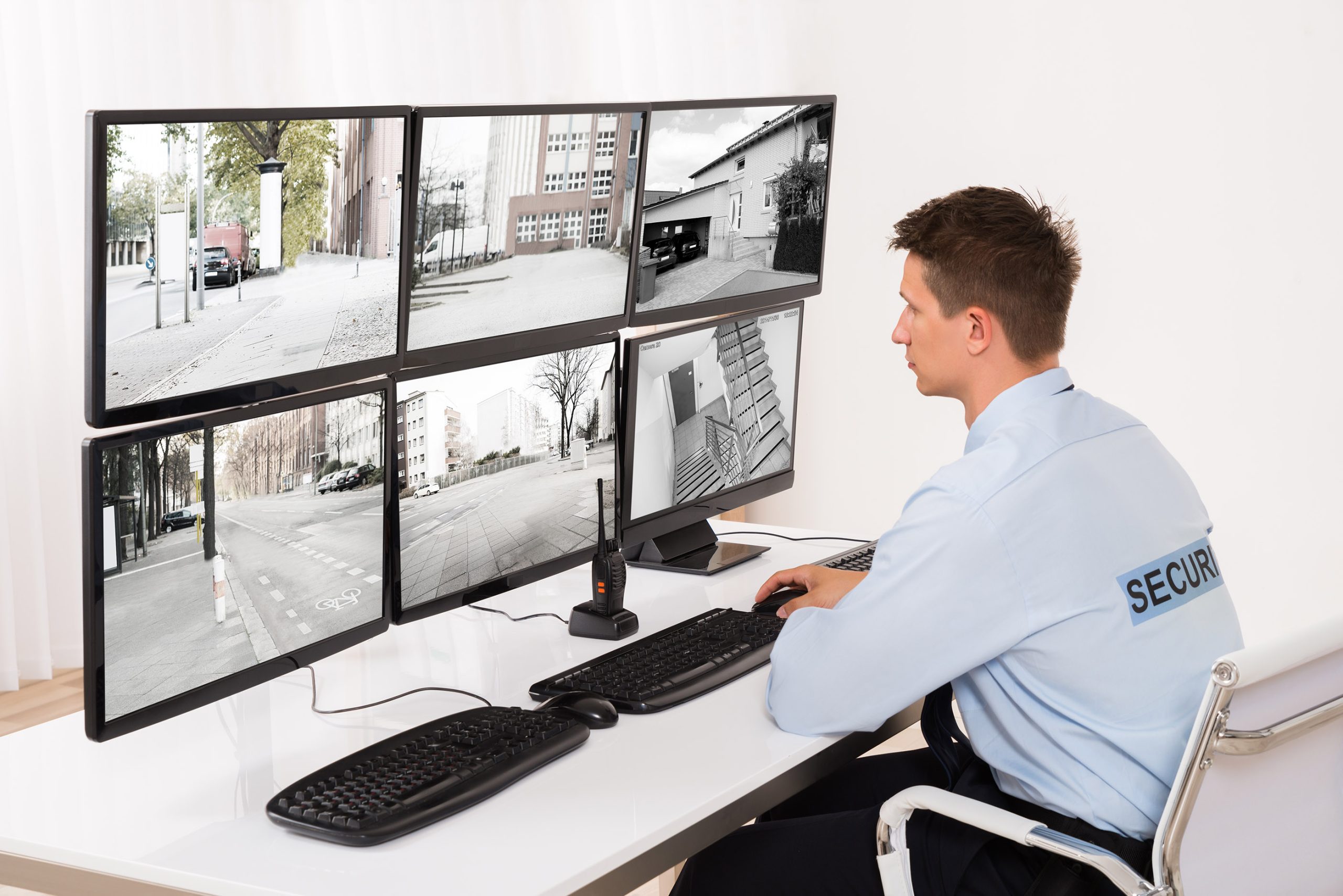Security Guard Monitoring Multiple CCTV Footage